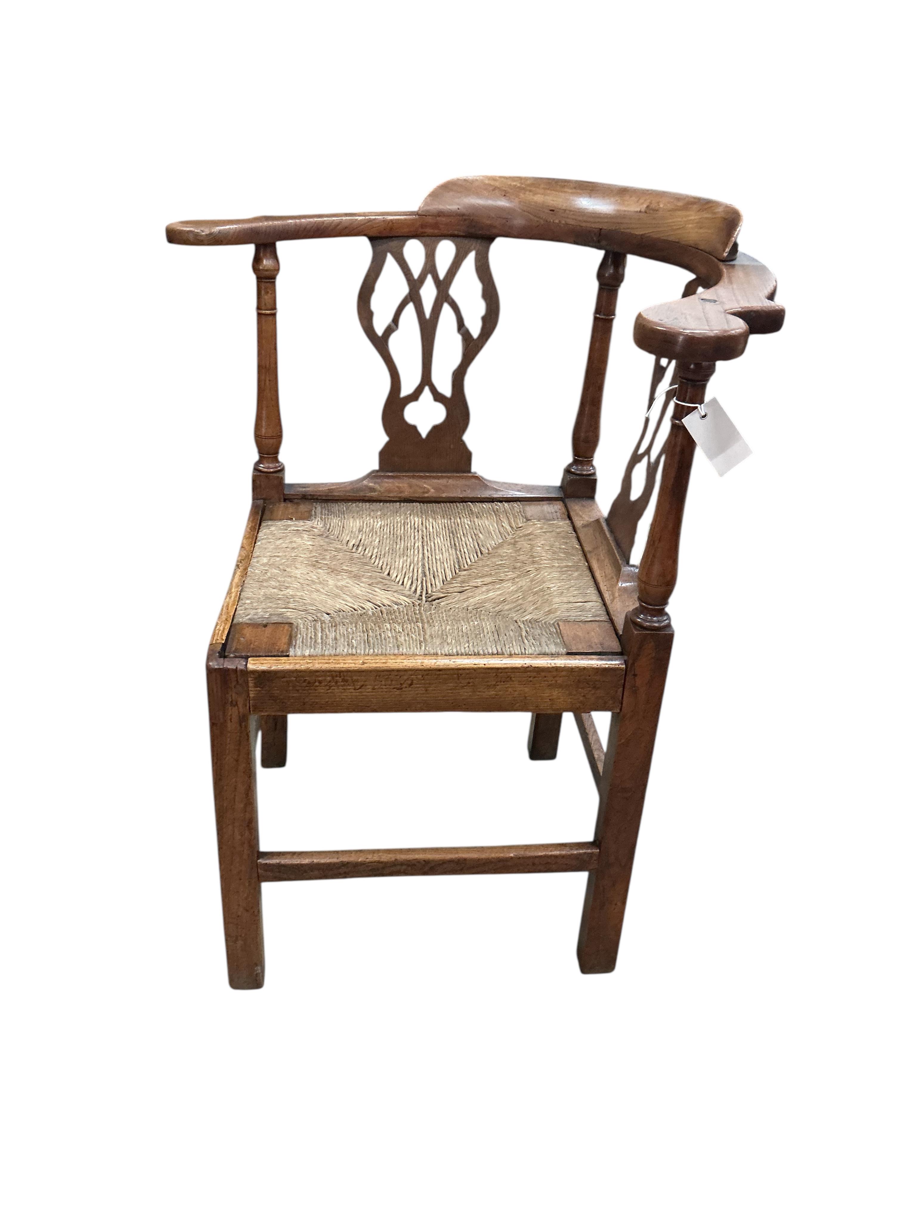 A George III oak corner elbow chair, width 75cm, depth 63cm, height 86cm